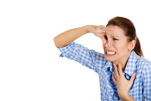 Closeup portrait of young beautiful, unhappy woman covers her nose, looks away, something stinks, very bad smell, situation, isolated on white background space to left Human facial expression, emotion