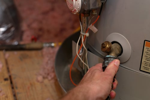 Man working on water heater